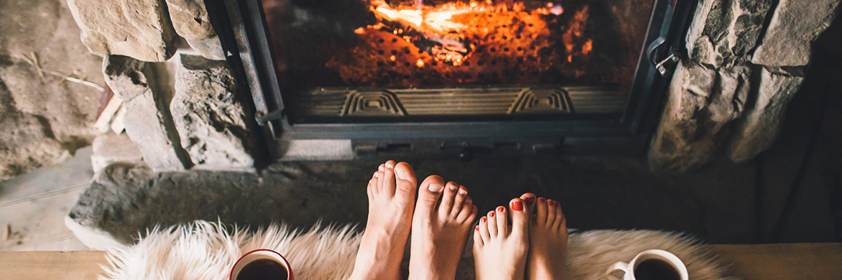 man and woman sitting on run in front of Shoreline fireplace