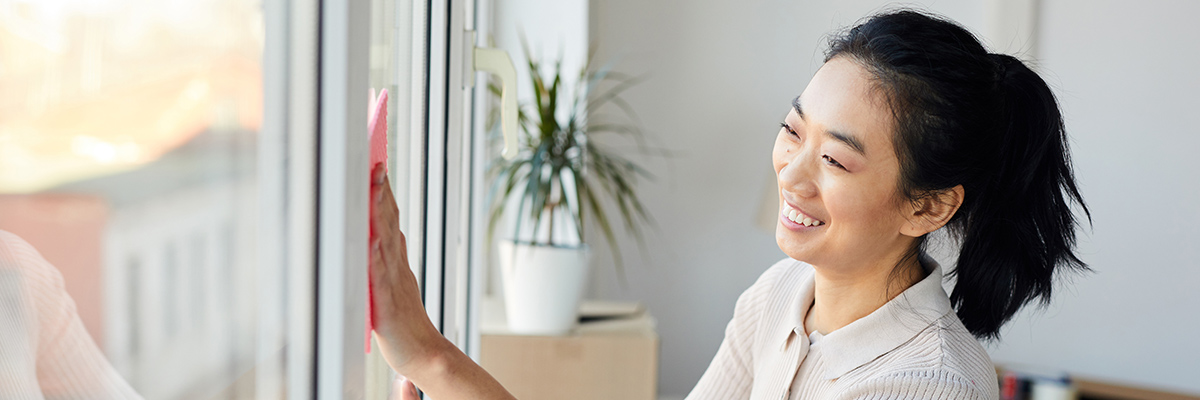 Woman cleaning inside of window