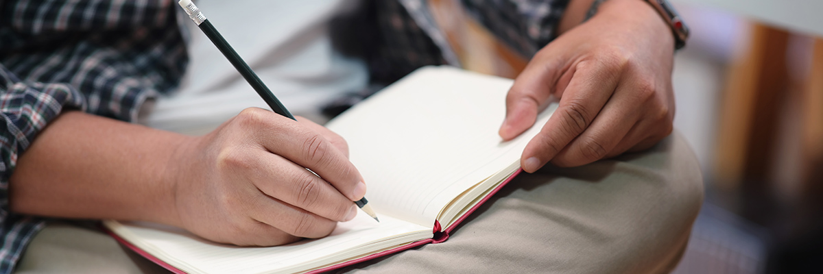 Man writing in journal
