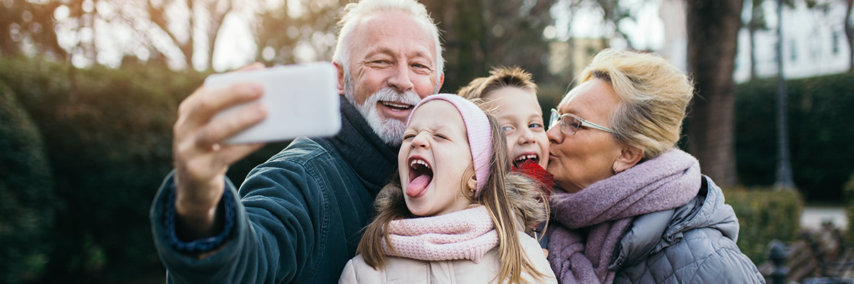 Senior couple taking photo with grandkids