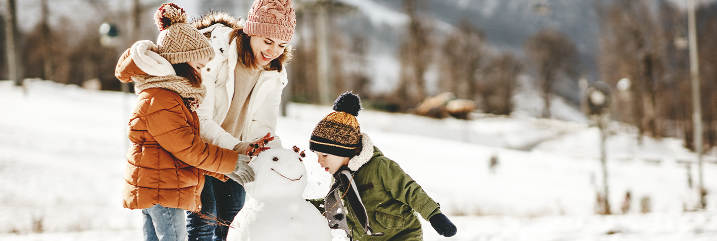 Family building a snowman