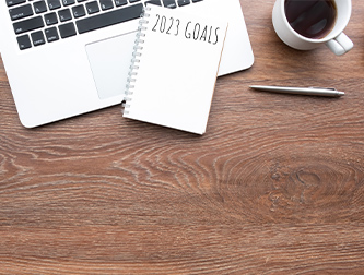 Laptop with notebook and goals