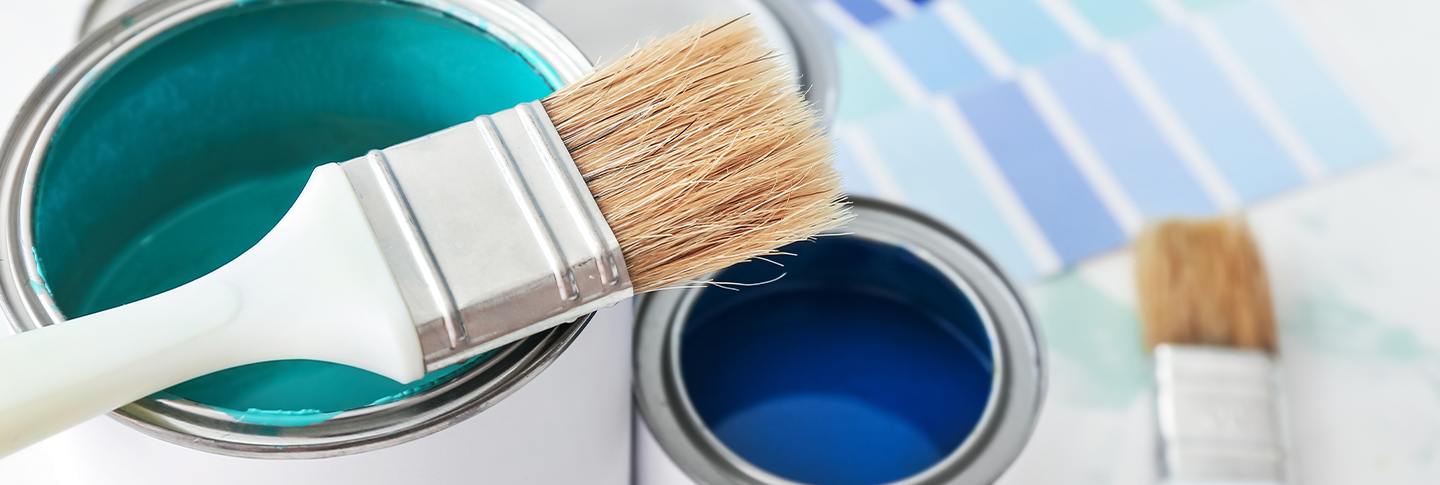 Paint brush with open paint cans